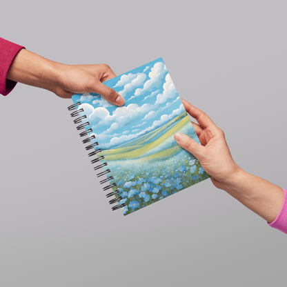 Inspiring notebook cover with a dreamy blue floral valley and soft countryside sky