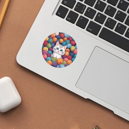 Fun cat art with vibrant yarn balls, perfect for your laptop, notebook, or phone.