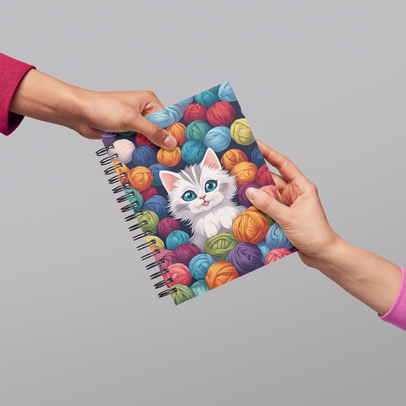 Cute kitten image surrounded by vibrant yarn on a notebook perfect for journaling or note-taking